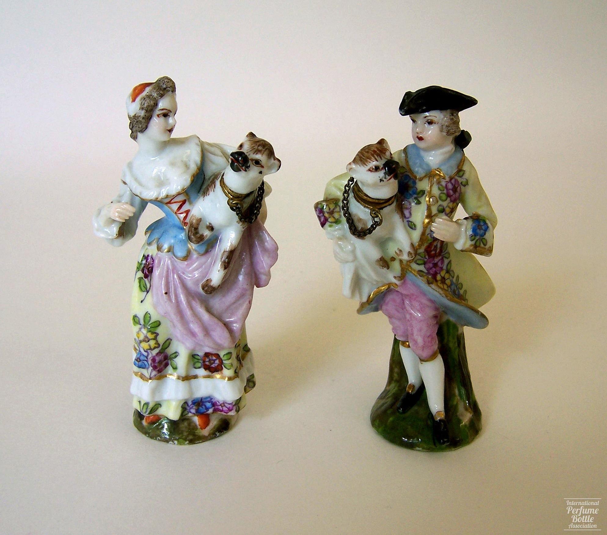 Lady and Man Holding Pug Dogs